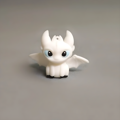 White mini dragon figure displayed on a desk