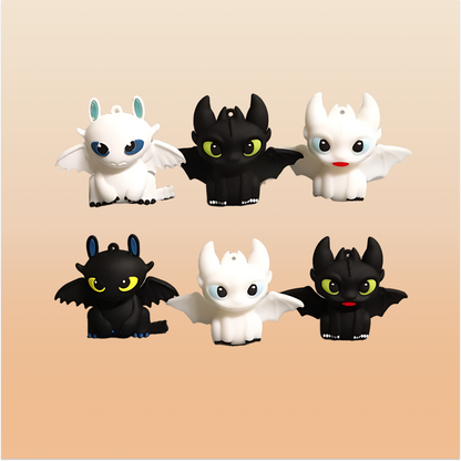 Set of black & white mini dragon figures on a neutral background