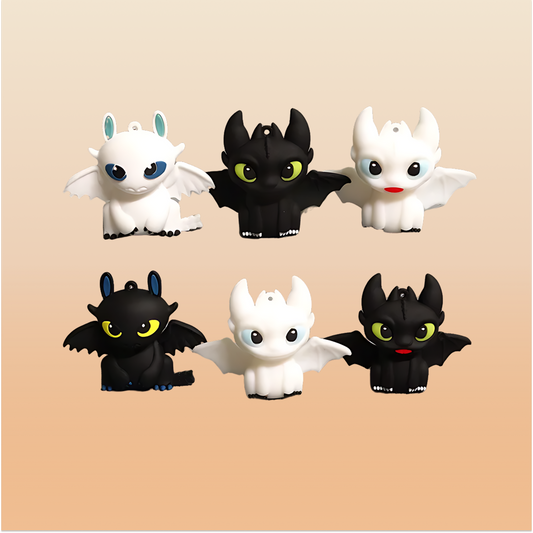 Set of black & white mini dragon figures on a neutral background