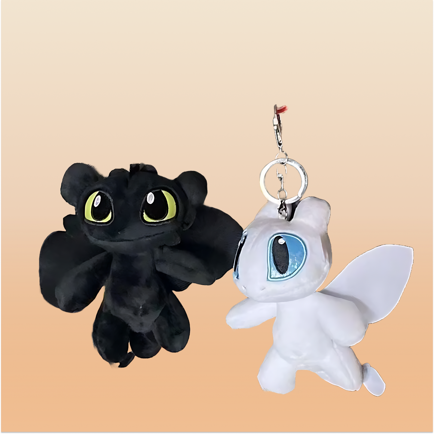 Black & white plush dragon keychains on a neutral background